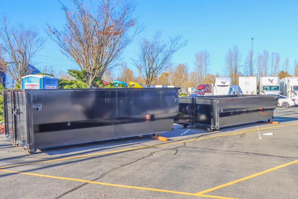 Professional dumpster rental service with roll-off container on residential driveway in Yeadon